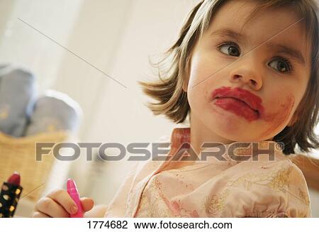 Young girl with lipstick View Large Photo Image Stock Image - Young girl with lipstick. Fotosearch