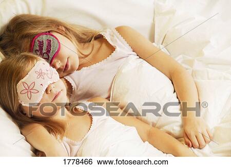 Young girls sleeping View Large Photo Image Stock Photograph - Young girls sleeping. Fotosearch