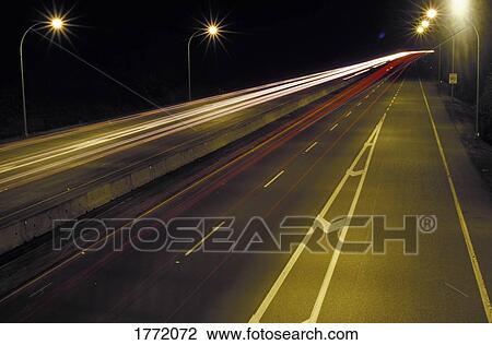 Stock Image - Car lights on highway at night. Fotosearch