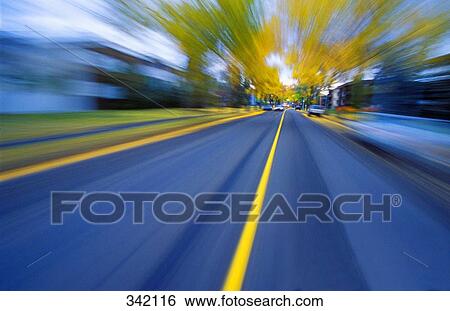 Stock Photograph - Speeding down a road in autumn. Fotosearch