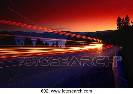 Stock Image - Time delay of headlights on mountain road. Fotosearch