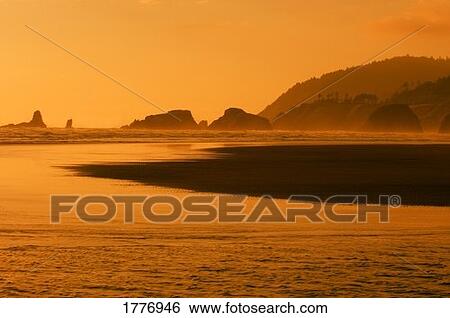 Stock Photograph - A body of water at sunset. Fotosearch