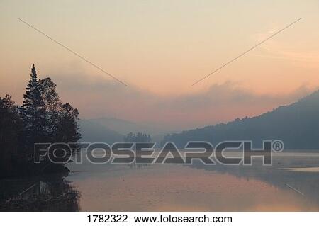 Stock Image - Mist and fog over water scenic. Fotosearch