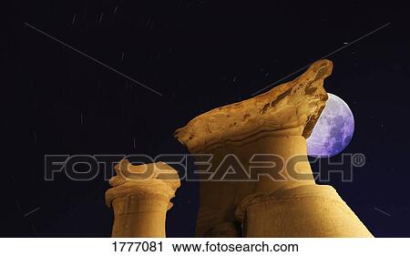 Stock Image - Strange rock formations and moon. Fotosearch