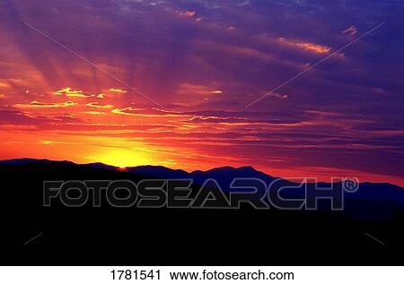 Stock Image - Sunrise in the mountains. Fotosearch