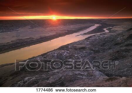 Stock Photograph - Sunset over rocky horizon. Fotosearch