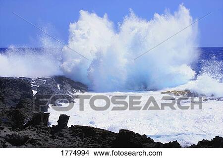 Picture - Waves crashing on rocks. Fotosearch
