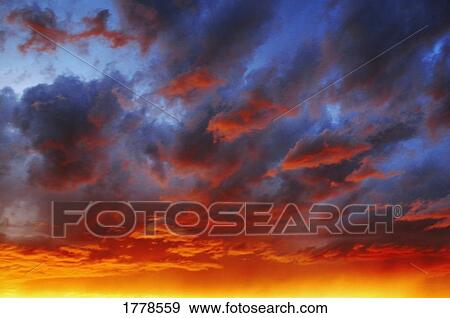 Stock Photo - A cloudy sunset. Fotosearch