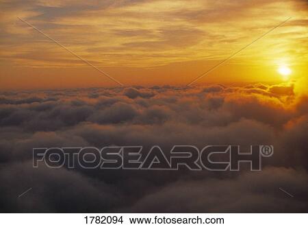 Picture - Cloud tops with rising sun. Fotosearch