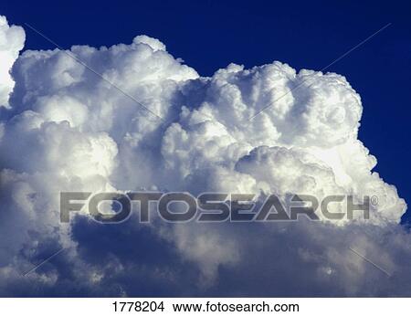 Clouds in a blue sky View Large Photo Image Picture - Clouds in a blue sky. Fotosearch
