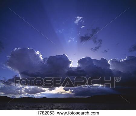 Clouds with sun breaking through View Large Photo Image Stock Image - Clouds with sun breaking through. Fotosearch