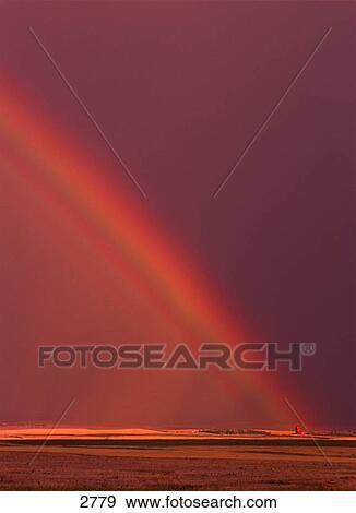 Stock Photo - Rainbow in a red sky. Fotosearch