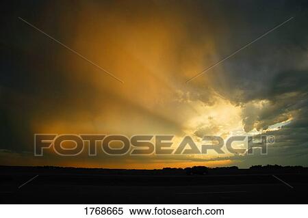 Sun bursting through the clouds View Large Photo Image Stock Photography - Sun bursting through the clouds. Fotosearch