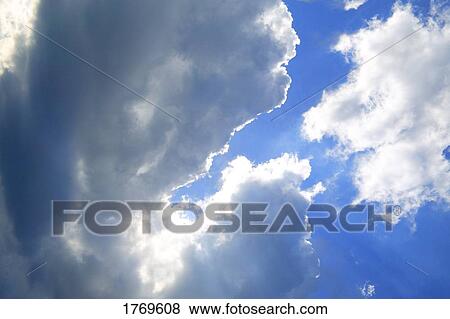 Sunlight peeking through the cloud View Large Photo Image Stock Photo - Sunlight peeking through the cloud. Fotosearch