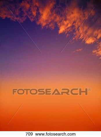 Sunset with a few cirrus clouds View Large Photo Image Stock Photo - Sunset with a few cirrus clouds. Fotosearch