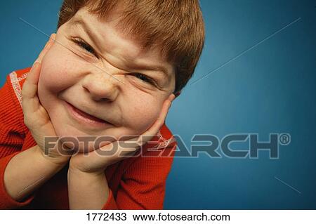 Stock Image - Boy with cheesy expression. Fotosearch