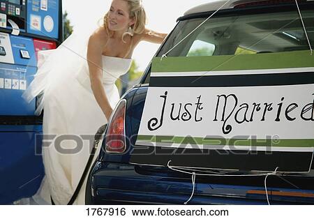 Stock Photograph - Bride fills car with gasoline. Fotosearch