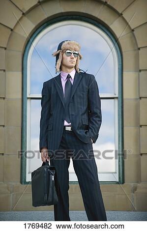 Stock Image - Businessman with suit and hat. Fotosearch