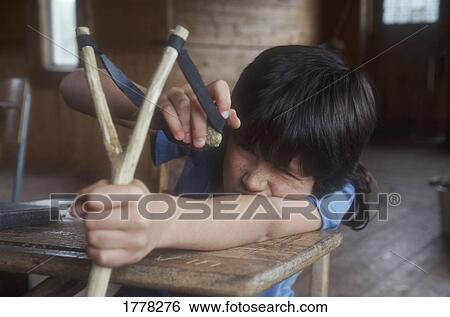 Child with a sling shot View Large Photo Image Stock Photograph - Child with a sling shot. Fotosearch