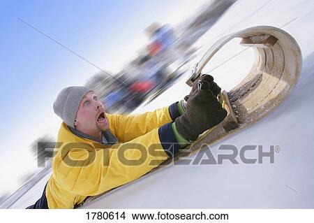 Man on a sled View Large Photo Image Picture - Man on a sled. Fotosearch