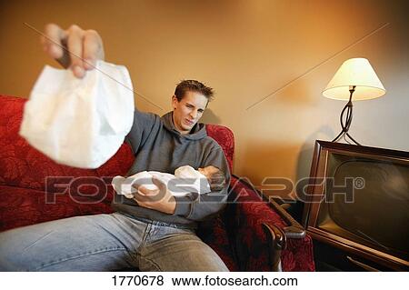 Stock Photo - Young man changing baby. Fotosearch