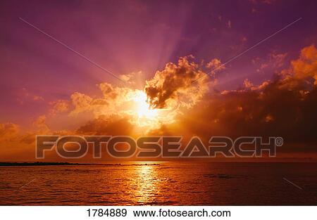 Stock Photo - Breathtaking sunset over water. Fotosearch