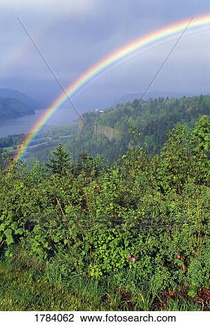 Stock Image - Rainbow over the Columbia River Gorge. Fotosearch
