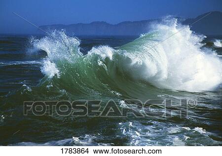 Wave crashing, distant storm, Cape Kiwanda View Large Photo Image Picture - Wave crashing, distant storm, Cape Kiwanda. Fotosearch