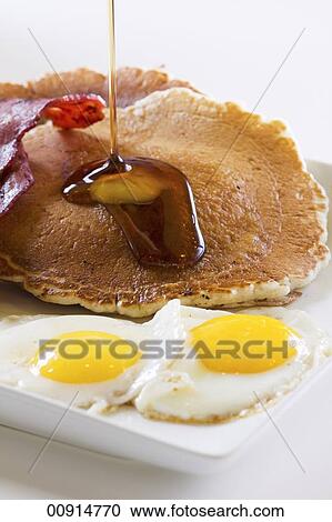 Stock Photography of Maple Syrup Pouring Over Pancakes; Fried Eggs and ...