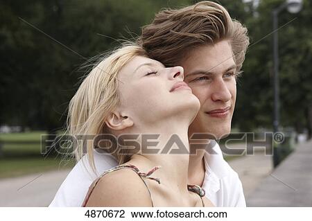 Stock Image - Affectionate young couple outdoors . Fotosearch