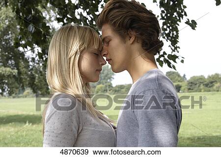Stock Photo - Affectionate young couple outdoors . Fotosearch