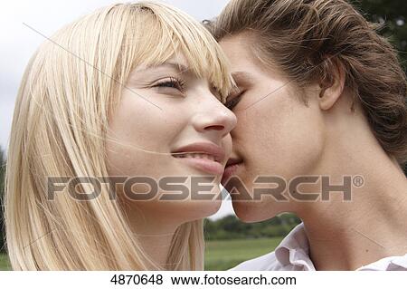 Stock Photo - Affectionate young couple outdoors . Fotosearch