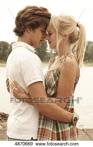 Stock Photo - Affectionate young couple outdoors . Fotosearch