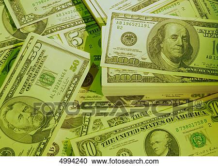 Stock Image - American banknotes in colored light . Fotosearch