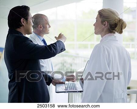Stock Photo - Architect discussing with doctors . Fotosearch