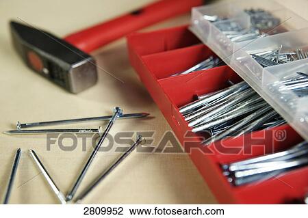 Stock Image - Assorted nails with hammer . Fotosearch