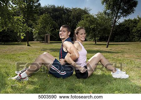 Stock Image - Athletic young couple outdoors . Fotosearch