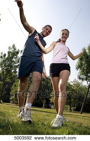 Stock Image - Athletic young couple outdoors . Fotosearch