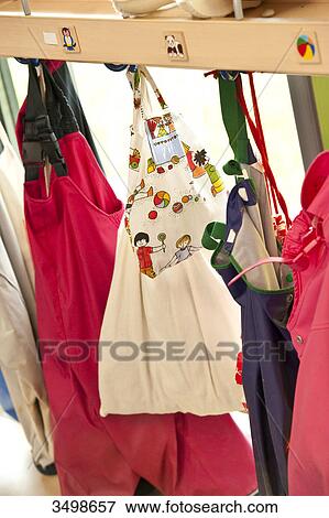 Stock Photo - Bags hanging on a coat rack . Fotosearch
