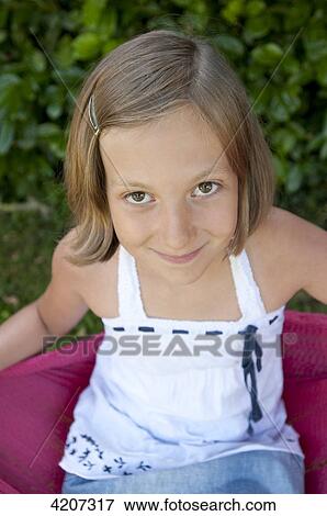 Stock Photo - Blond girl smiling at camera . Fotosearch