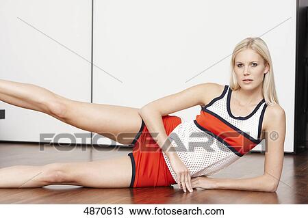Stock Image - Blond young woman exercising . Fotosearch