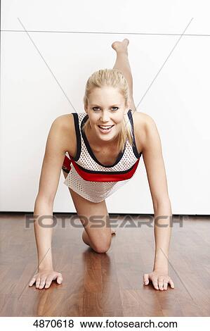 Stock Photo - Blond young woman exercising . Fotosearch