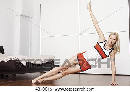 Blond young woman exercising View Large Photo Image Stock Photography - Blond young woman exercising . Fotosearch