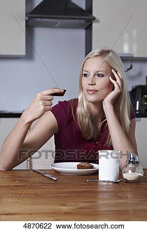Blond young woman looking at pastry View Large Photo Image Stock Image - Blond young woman looking at pastry . Fotosearch