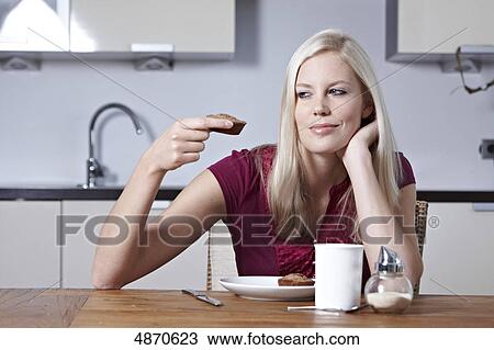 Blond young woman looking at pastry View Large Photo Image Stock Image - Blond young woman looking at pastry . Fotosearch