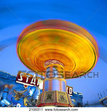 Blurred view of carousel in amusement park, Munich Beer Festival, Munich, Bavaria, Germany View Large Photo Image Stock Image - Blurred view of carousel in amusement park, Munich Beer Festival, Munich, Bavaria, Germany . Fotosearch