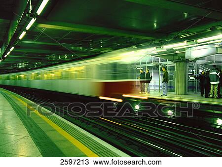 Stock Image - Blurred view of train leaving station . Fotosearch
