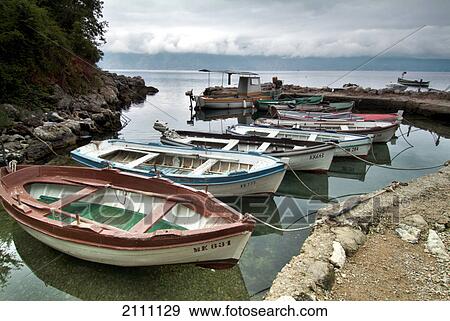 Stock Photo - Boats moored at harbor . Fotosearch