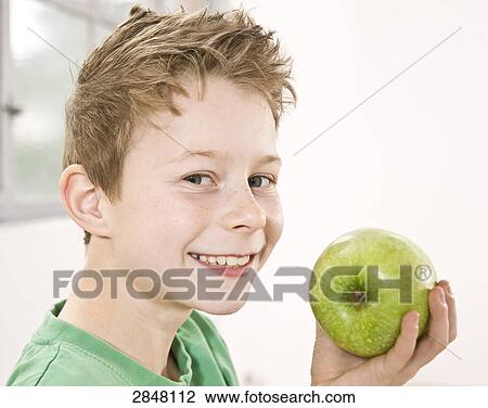 Boy having granny smith apple and smiling View Large Photo Image Stock Image - Boy having granny smith apple and smiling . Fotosearch