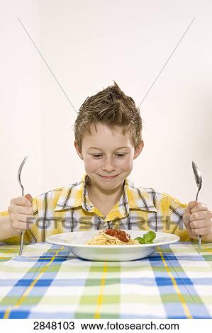 Stock Image - Boy having noodles . Fotosearch